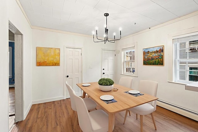 67-69 Nesmith St, Lawrence, MA 01841 - dining room with baseboard heating, a chandelier, and wood finished floors