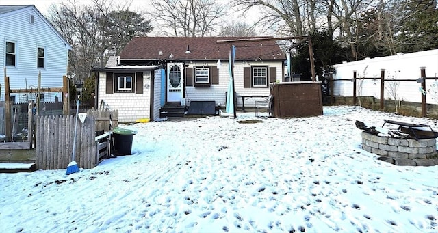 snow covered property featuring an outdoor fire pit