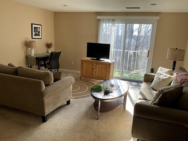 living room featuring visible vents, baseboards, and light colored carpet