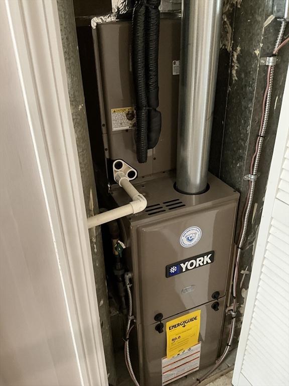 utility room featuring heating unit