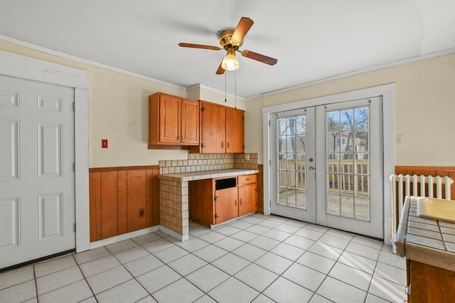 kitchen featuring french doors, tasteful backsplash, light tile patterned floors, and ceiling fan