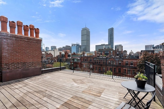 wooden deck featuring a skyline view