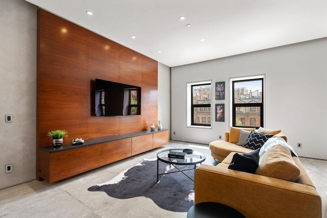living area with recessed lighting and concrete floors