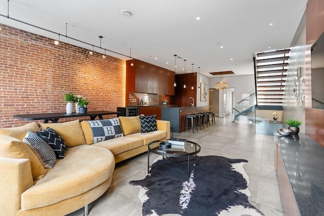 living room with stairway and brick wall