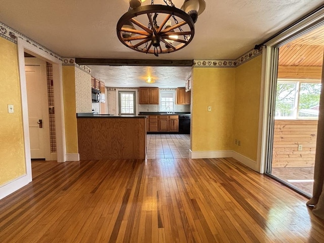 45 Gardner Rd, Hubbardston, MA 01452 - unfurnished living room featuring hardwood / wood-style flooring, a sink, baseboards, a chandelier, and a textured ceiling