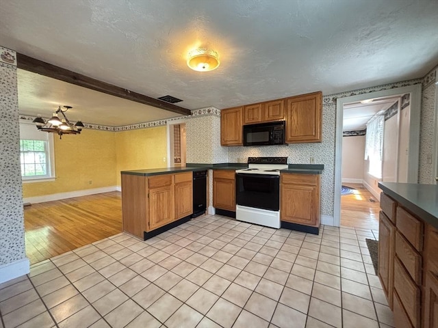 45 Gardner Rd, Hubbardston, MA 01452 - kitchen featuring black appliances, dark countertops, light tile patterned flooring, a peninsula, and a textured ceiling