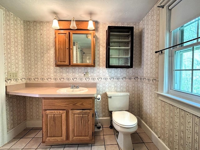 45 Gardner Rd, Hubbardston, MA 01452 - bathroom featuring tile patterned flooring, toilet, vanity, wallpapered walls, and baseboards