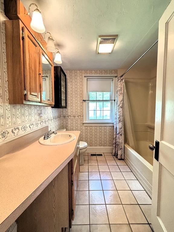 45 Gardner Rd, Hubbardston, MA 01452 - bathroom featuring wallpapered walls, toilet, shower / tub combo with curtain, vanity, and tile patterned floors
