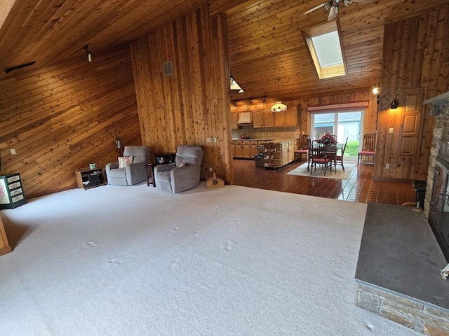 6 Nevada, Freetown, MA 02702 - misc room with wooden walls, a fireplace, a towering ceiling, carpet floors, and a skylight