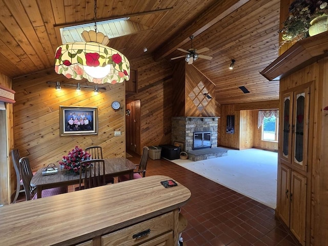 6 Nevada, Freetown, MA 02702 - dining space featuring wood walls, a stone fireplace, ceiling fan, and a wood ceiling with exposed beams