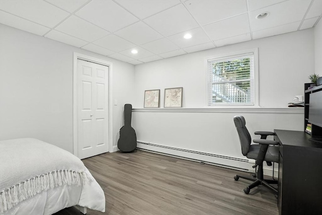 134 Lincoln St, Norwell, MA 02061 - bedroom with a baseboard radiator, a drop ceiling, wood finished floors, an office area, and recessed lighting