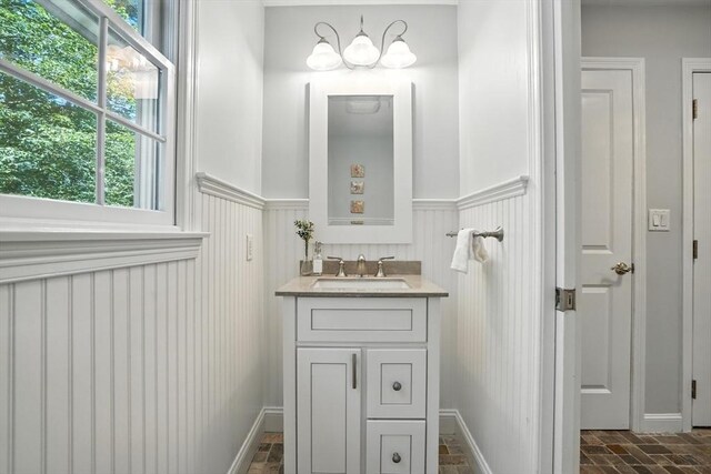 134 Lincoln St, Norwell, MA 02061 - bathroom featuring vanity, a wainscoted wall, and brick patterned floors