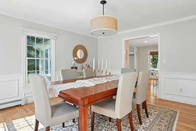 134 Lincoln St, Norwell, MA 02061 - dining space featuring baseboard heating, light wood-style floors, wainscoting, ornamental molding, and a decorative wall