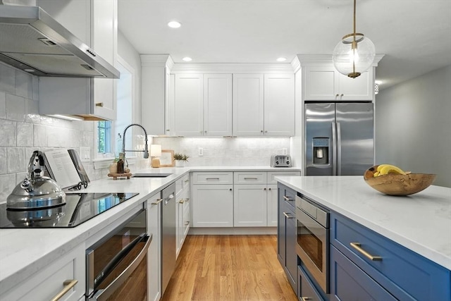 134 Lincoln St, Norwell, MA 02061 - kitchen with extractor fan, stainless steel appliances, blue cabinets, white cabinetry, and recessed lighting
