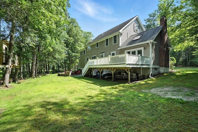 134 Lincoln St, Norwell, MA 02061 - rear view of property featuring a chimney, a wooden deck, a lawn, stairway, and a shingled roof