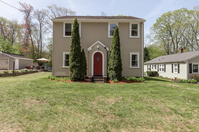 view of front of home featuring entry steps and a front lawn