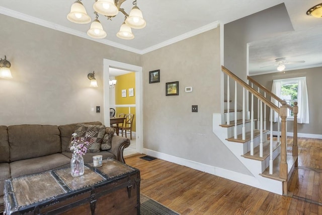 living area with baseboards, stairs, and wood finished floors