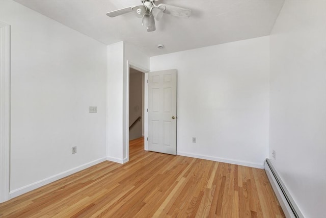 unfurnished room with baseboards, a ceiling fan, light wood-style flooring, and a baseboard heating unit
