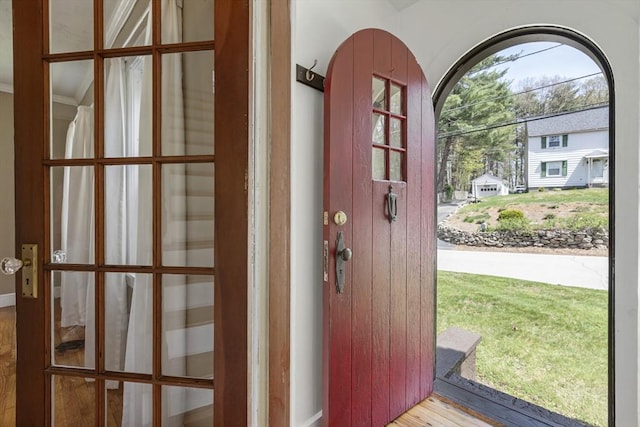 doorway featuring baseboards and wood finished floors