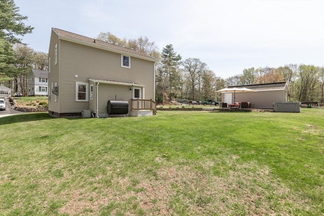 rear view of house with a lawn and heating fuel