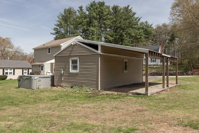 view of side of property featuring a lawn and an attached carport
