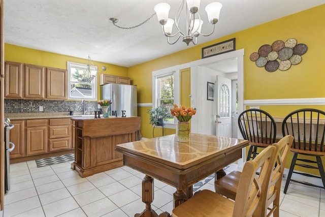 dining room with light tile patterned flooring and a chandelier