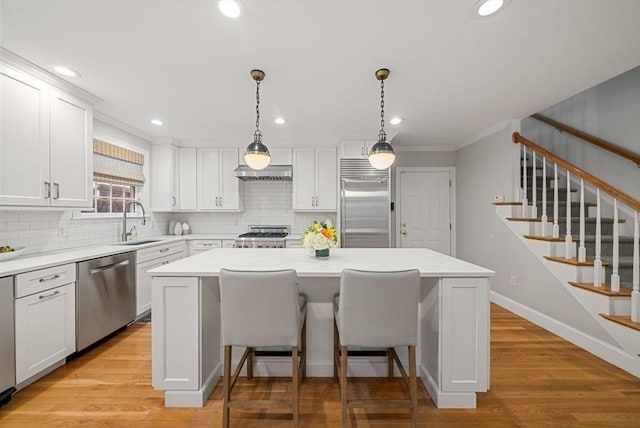 kitchen with white cabinetry, appliances with stainless steel finishes, and a kitchen island