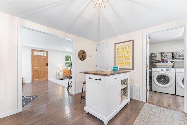117 Woodland Dr, Lunenburg, MA 01462 - kitchen with washer and clothes dryer, dark wood finished floors, white cabinetry, a kitchen breakfast bar, and open shelves