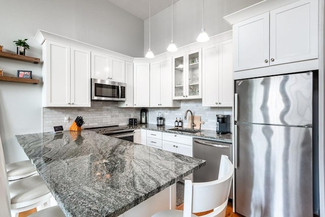 743 E 4th Unit 204, Boston, MA 02127 - kitchen with appliances with stainless steel finishes, a sink, a kitchen breakfast bar, and a peninsula