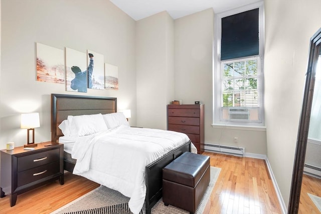 743 E 4th Unit 204, Boston, MA 02127 - bedroom with a baseboard heating unit, hardwood / wood-style floors, baseboards, and cooling unit