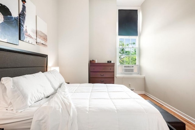 743 E 4th Unit 204, Boston, MA 02127 - bedroom featuring wood finished floors, baseboards, and cooling unit