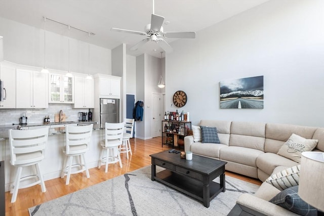 743 E 4th Unit 204, Boston, MA 02127 - living room with track lighting, high vaulted ceiling, a ceiling fan, and light wood finished floors