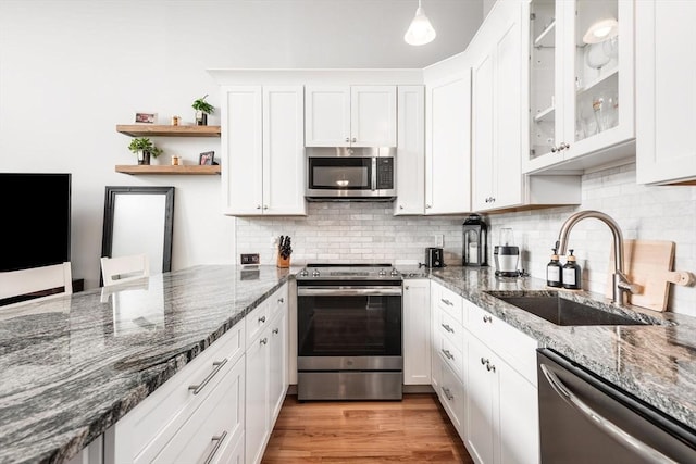 743 E 4th Unit 204, Boston, MA 02127 - kitchen with stainless steel appliances, a sink, white cabinetry, and tasteful backsplash
