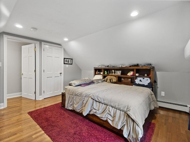 886 Methuen St, Dracut, MA 01826 - bedroom featuring baseboard heating, light wood-style flooring, vaulted ceiling, and recessed lighting