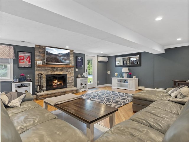 886 Methuen St, Dracut, MA 01826 - living area featuring an AC wall unit, wood finished floors, a stone fireplace, ornamental molding, and a baseboard radiator