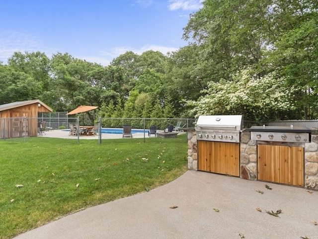 886 Methuen St, Dracut, MA 01826 - fenced backyard featuring exterior kitchen, a patio area, and view of wooded area