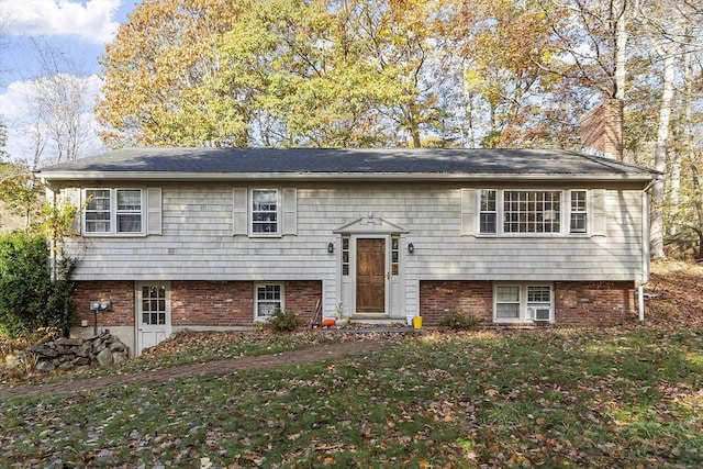 raised ranch with a front yard