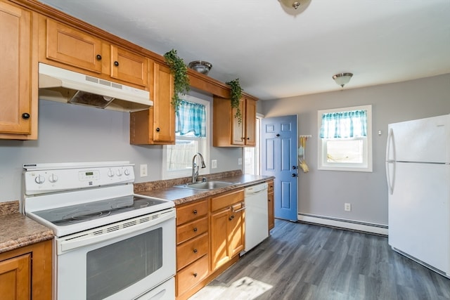 kitchen with sink, white appliances, baseboard heating, and a wealth of natural light