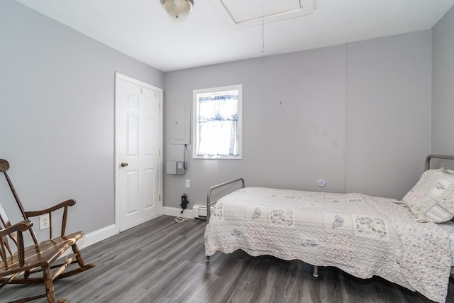 bedroom with hardwood / wood-style flooring and baseboard heating