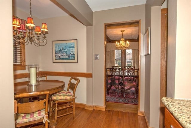 dining area with an inviting chandelier and light hardwood / wood-style flooring