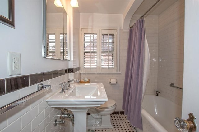 bathroom with tile walls, tile patterned floors, and shower / bath combination with curtain