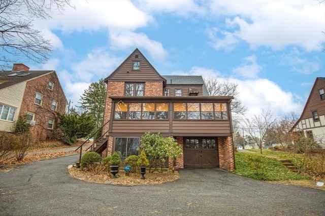 tudor house featuring a sunroom