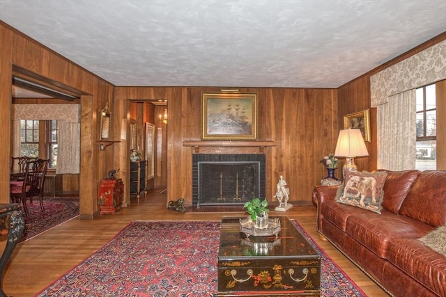 living room featuring plenty of natural light, a textured ceiling, and hardwood / wood-style flooring