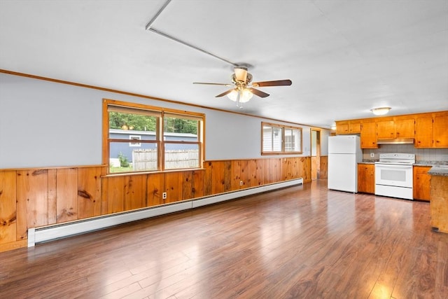 24 Horton Rd, Orange, MA 01364 - unfurnished living room featuring baseboard heating, wooden walls, a wainscoted wall, wood finished floors, and a ceiling fan