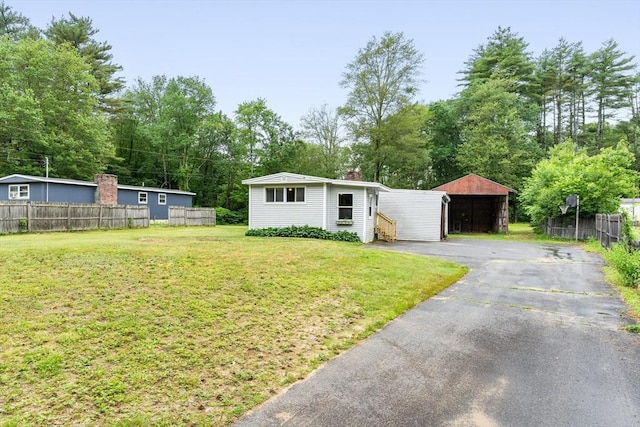 24 Horton Rd, Orange, MA 01364 - view of front of property with a chimney, asphalt driveway, an outdoor structure, and view of wooded area