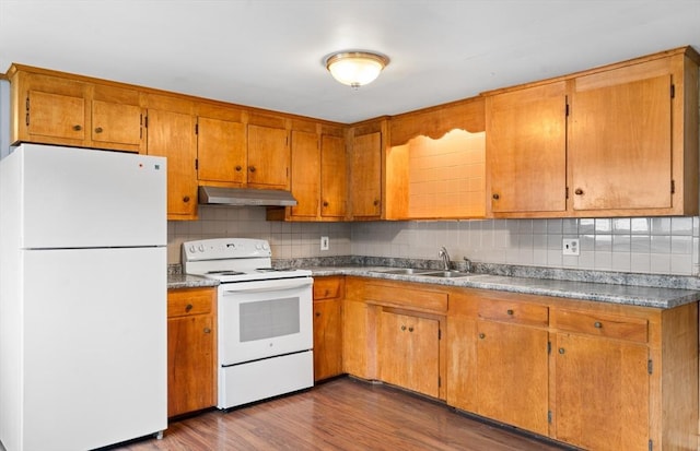 24 Horton Rd, Orange, MA 01364 - kitchen featuring white appliances, under cabinet range hood, tasteful backsplash, dark wood-type flooring, and brown cabinets