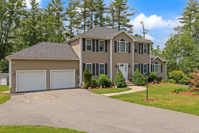 1 Windsor Rd, Shirley, MA 01464 - colonial-style house featuring driveway, a front lawn, and a garage