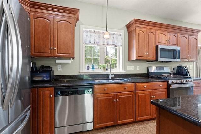 1 Windsor Rd, Shirley, MA 01464 - kitchen featuring stainless steel appliances, pendant lighting, dark stone countertops, and brown cabinetry