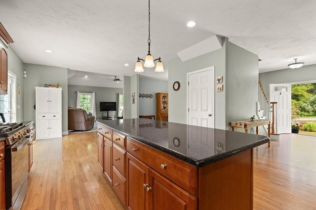 1 Windsor Rd, Shirley, MA 01464 - kitchen featuring stainless steel gas range, light wood-style flooring, a center island, open floor plan, and recessed lighting
