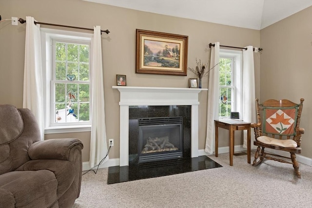 1 Windsor Rd, Shirley, MA 01464 - living area featuring carpet, plenty of natural light, a fireplace with flush hearth, and lofted ceiling